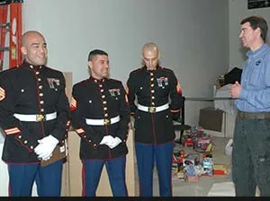 Marines in dress blues at a holiday gift drop