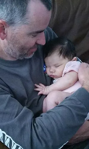 With his grandbaby on the couch