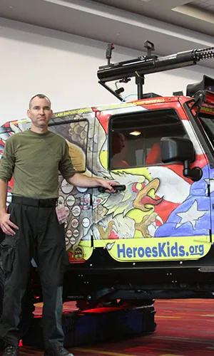 Beside the HeroesKids.org rig at SEMA