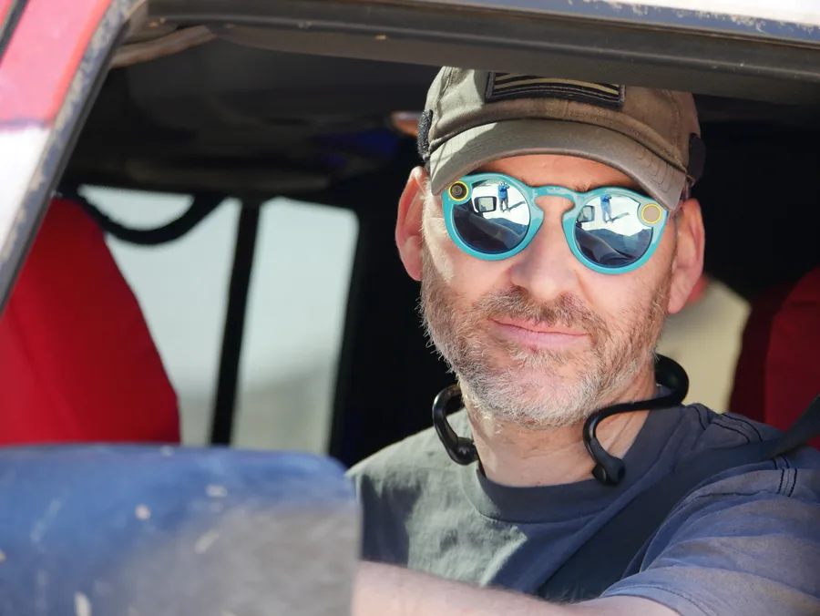 Behind the wheel, sunglasses on, out on the trail