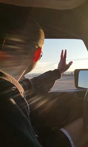 Hand out the window at sunset ... the Jeep wave