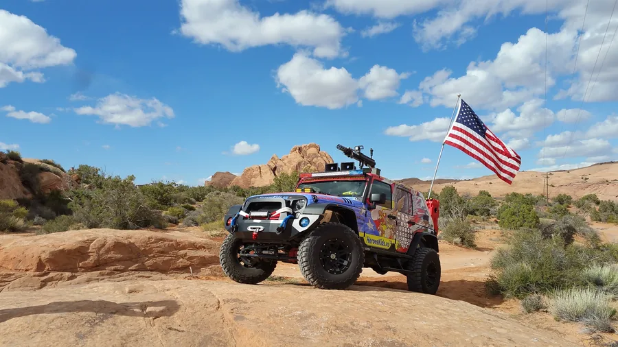 The rig parked in red rock country, flag flying