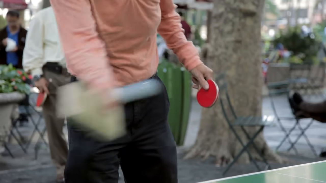 Player uses wood block paddle.