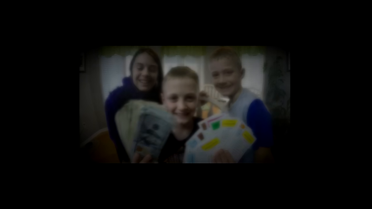 Children holding cash and game cards