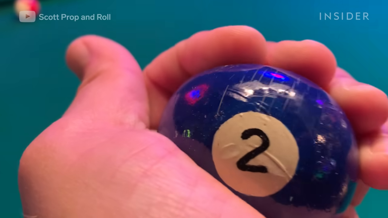 Hand holding blue 2-ball