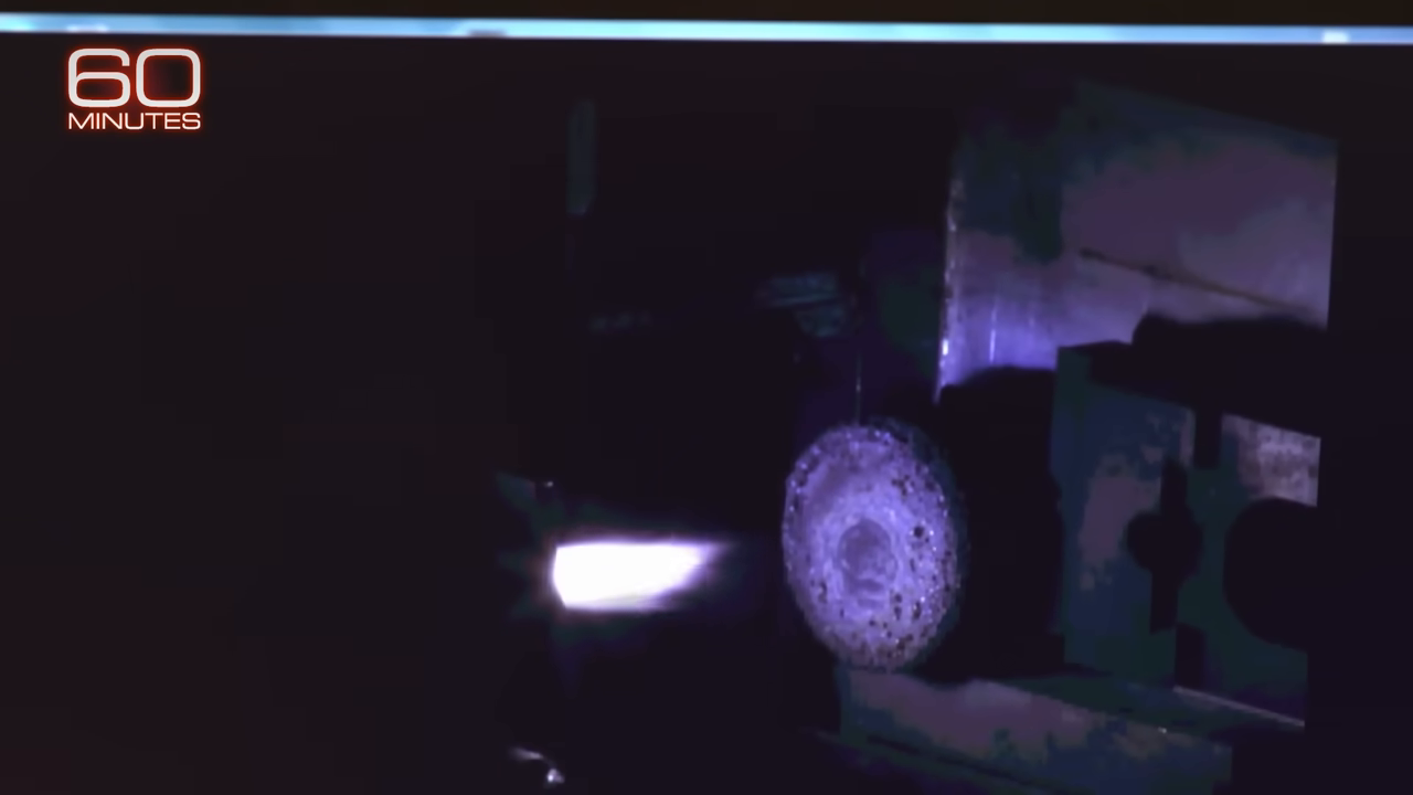 NASA's bright plasma torch blasting a regolith sample inside a testing chamber to simulate rocket exhaust.