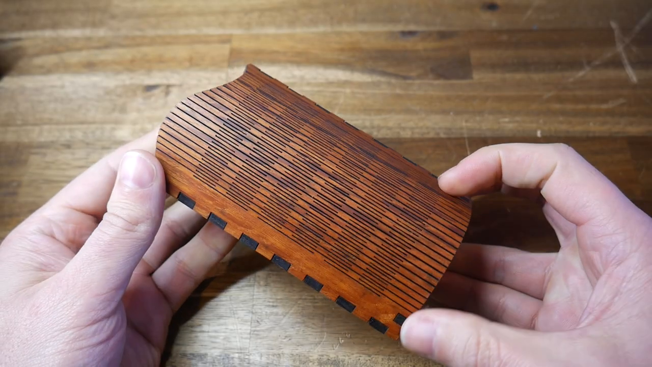 Close-up of the laser-cut wooden box that inspired the 3D printed design, showing the intricate slot pattern.